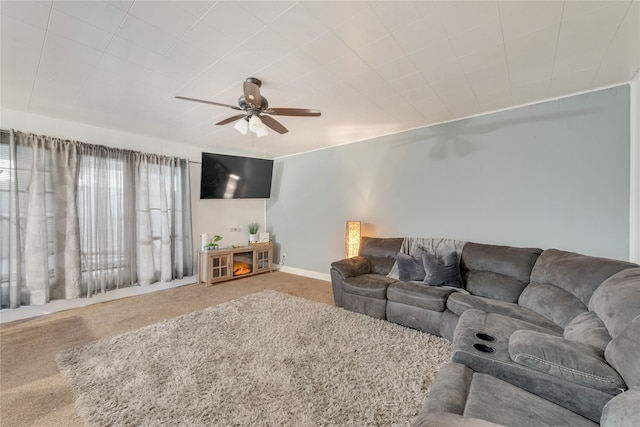 carpeted living room with ceiling fan