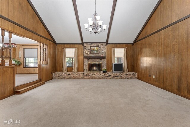 unfurnished living room featuring light colored carpet, wooden walls, vaulted ceiling with beams, and a notable chandelier