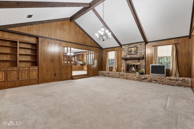 unfurnished living room featuring beamed ceiling, wooden walls, and a notable chandelier