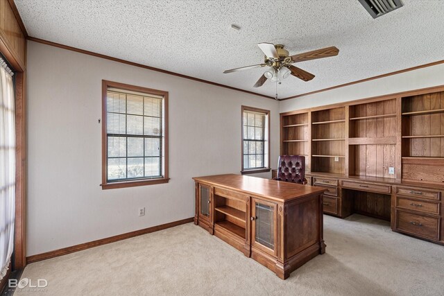 office with built in desk, a textured ceiling, and a wealth of natural light