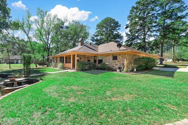 back of property featuring a lawn