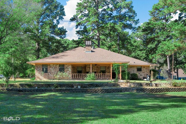 ranch-style house with a porch and a front yard