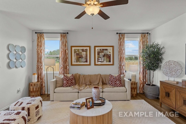 living room with a healthy amount of sunlight, ceiling fan, and wood finished floors