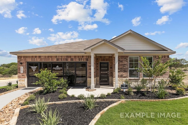 view of front of home featuring a garage, brick siding, and driveway