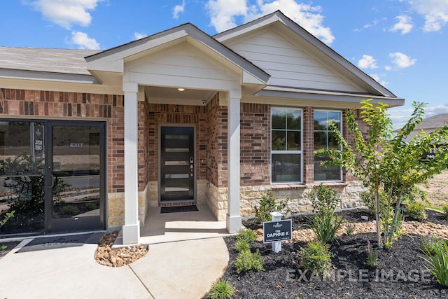 doorway to property featuring brick siding