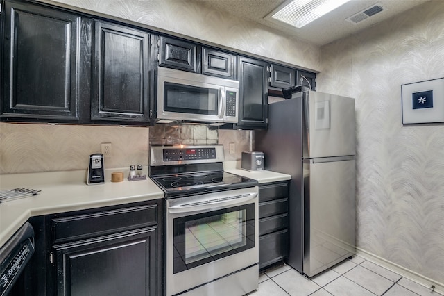 kitchen featuring stainless steel appliances and light tile patterned floors