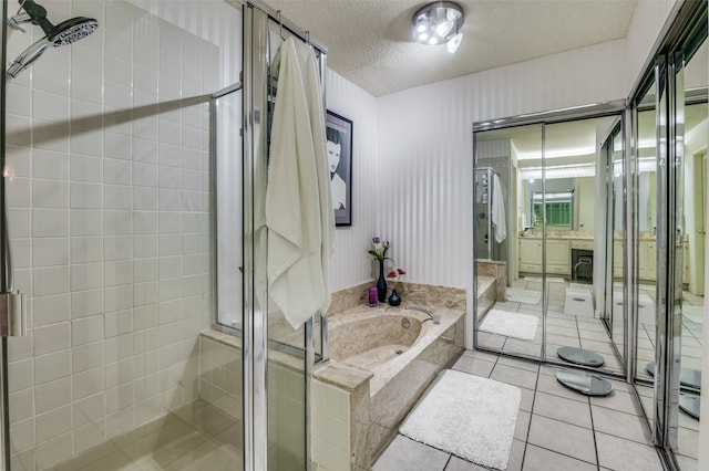 bathroom featuring vanity, tile patterned floors, plus walk in shower, and a textured ceiling