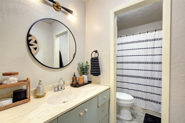 bathroom with vanity, a textured ceiling, toilet, and a shower with curtain