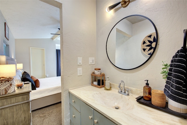 bathroom featuring lofted ceiling, a textured ceiling, and vanity