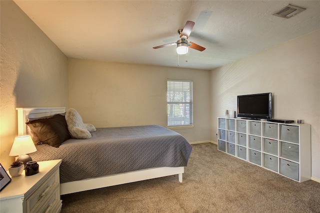 bedroom featuring ceiling fan and light carpet