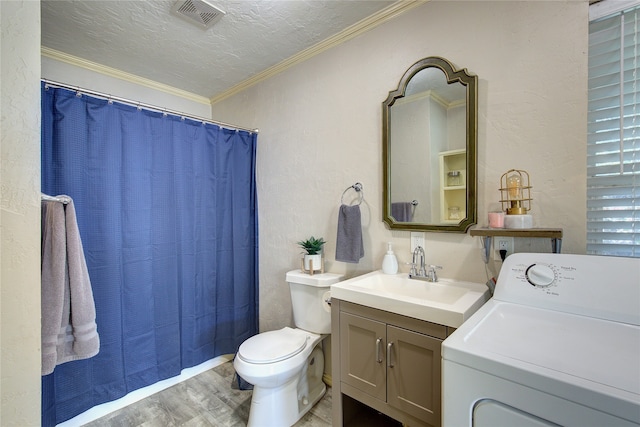 bathroom with wood-type flooring, a textured ceiling, ornamental molding, vanity, and washer / clothes dryer