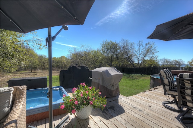 wooden deck featuring a grill