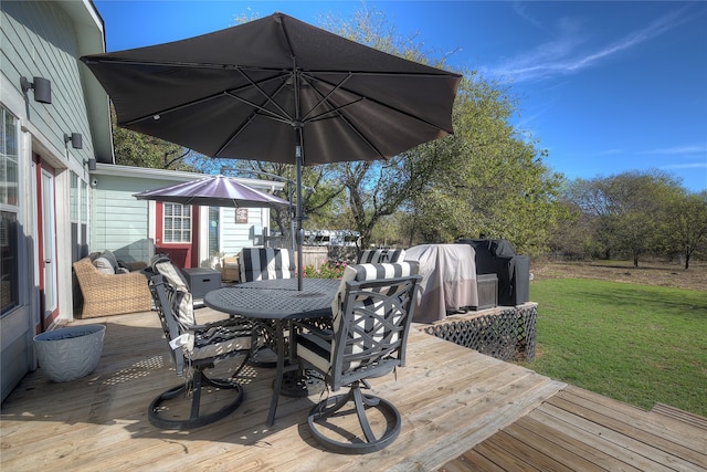 wooden deck featuring a yard