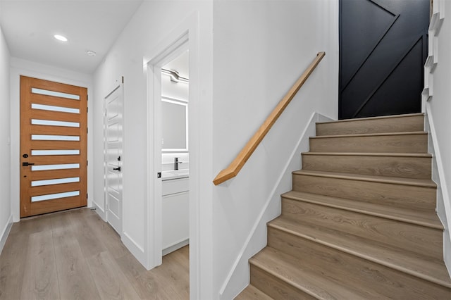 stairs featuring hardwood / wood-style floors