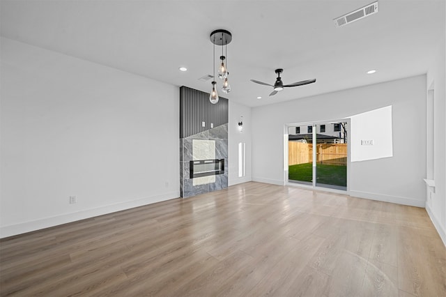 unfurnished living room featuring ceiling fan and light hardwood / wood-style floors