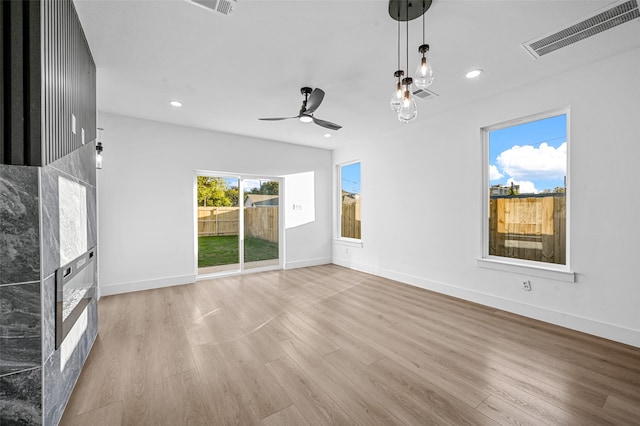 unfurnished living room with light hardwood / wood-style floors and ceiling fan