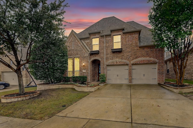 view of front of house with a yard and a garage