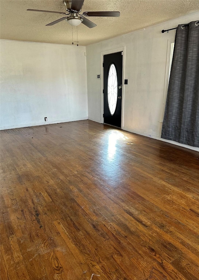 foyer with dark hardwood / wood-style flooring, ceiling fan, and a textured ceiling