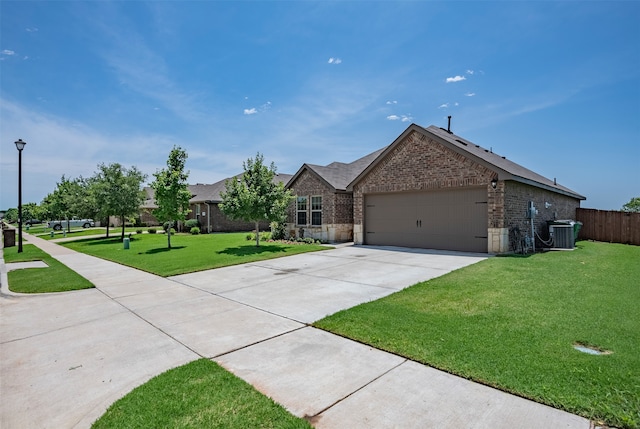 single story home featuring a garage, central air condition unit, and a front yard