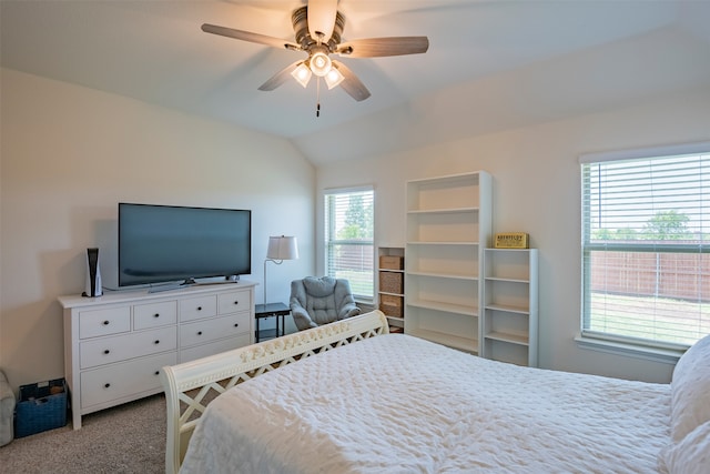 bedroom featuring multiple windows, ceiling fan, light carpet, and lofted ceiling