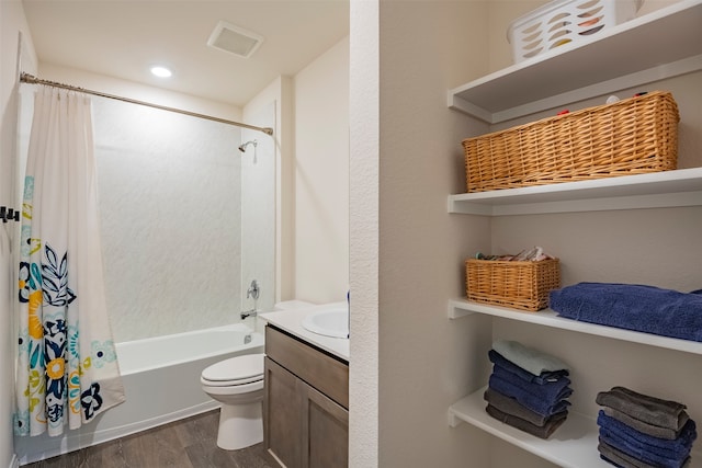 full bathroom with shower / tub combo, vanity, hardwood / wood-style flooring, and toilet