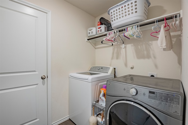 clothes washing area with washing machine and dryer