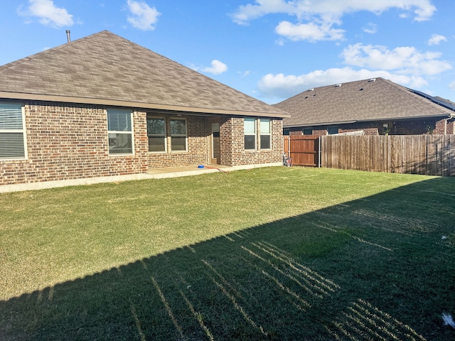 back of house featuring a yard