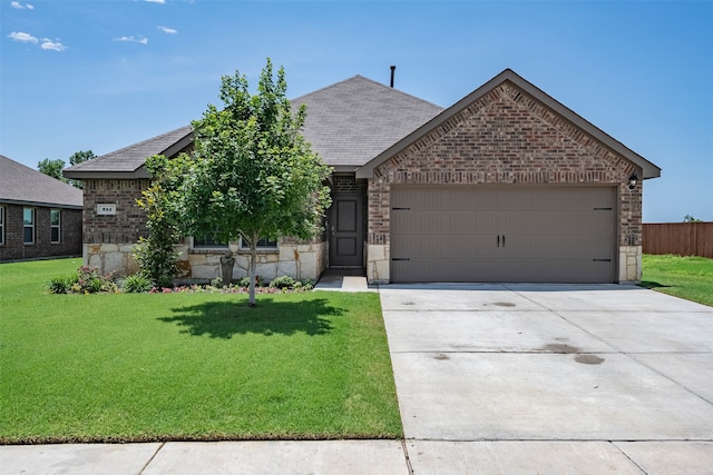 view of front of house featuring a front yard and a garage