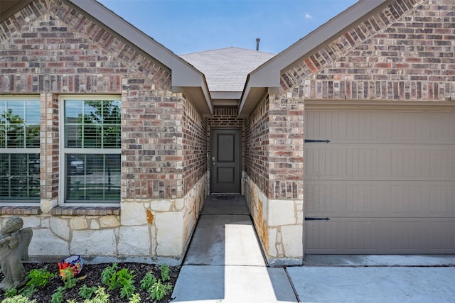 view of exterior entry with a garage