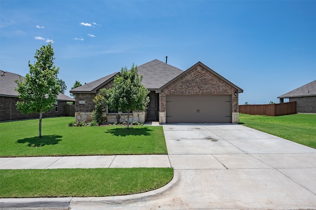 view of front of property featuring a garage and a front lawn