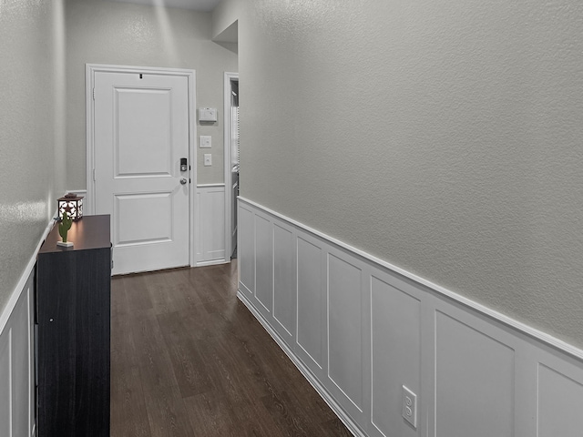 corridor with dark wood-type flooring