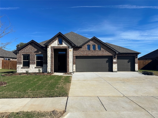 view of front of house with a garage and a front lawn