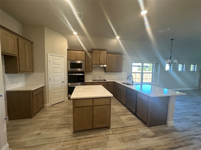 kitchen with light hardwood / wood-style flooring, appliances with stainless steel finishes, and a center island