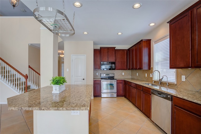 kitchen featuring light stone countertops, appliances with stainless steel finishes, and tasteful backsplash