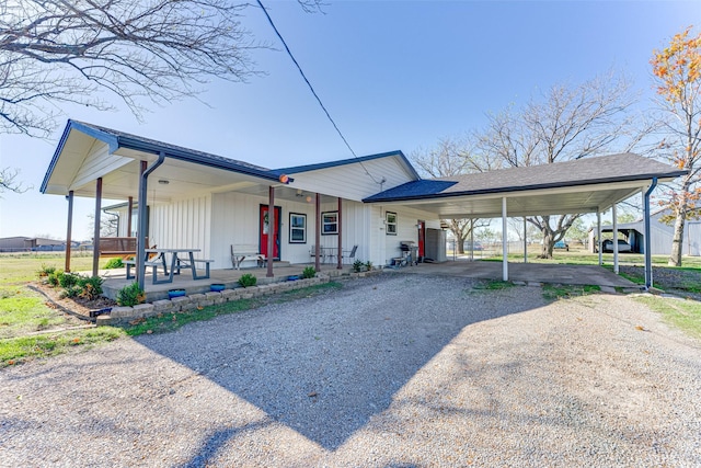 view of front of house featuring a carport and covered porch