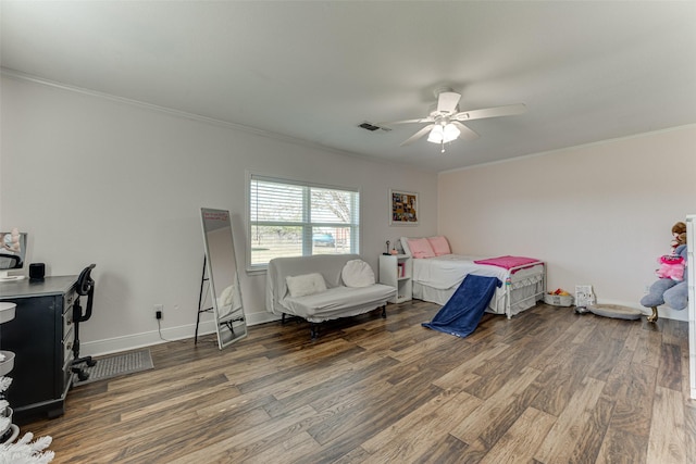 bedroom featuring ceiling fan, dark wood-type flooring, and ornamental molding