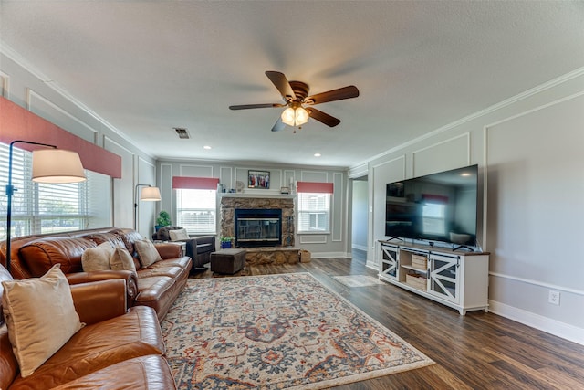 living room with ceiling fan, ornamental molding, and wood-type flooring