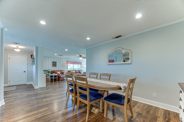 dining area featuring ceiling fan, dark hardwood / wood-style floors, and ornamental molding