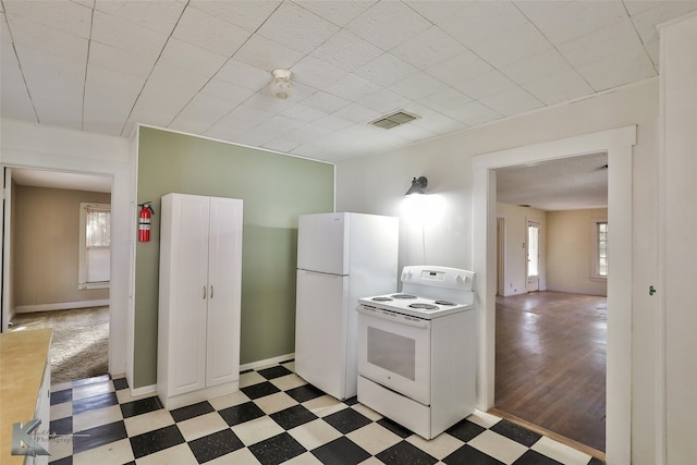 kitchen with dark hardwood / wood-style flooring and white appliances