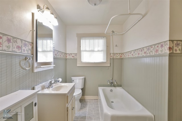 full bathroom with shower / bathing tub combination, vanity, toilet, and a wealth of natural light