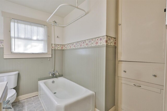 bathroom featuring bathtub / shower combination, tile patterned floors, and toilet