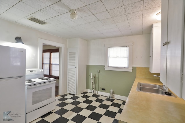 kitchen with a wealth of natural light, sink, and white appliances