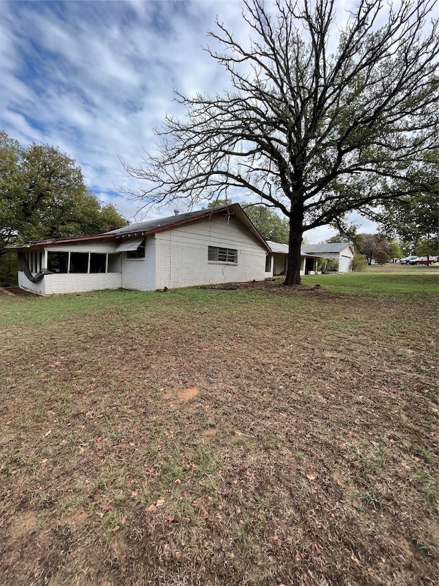 view of side of home featuring a yard