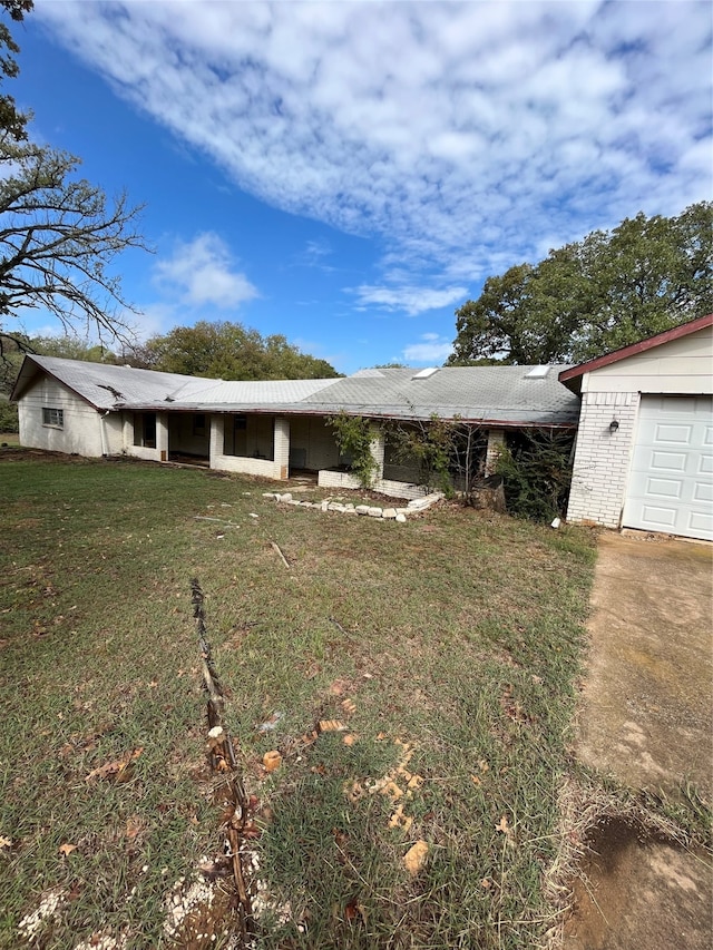 exterior space with a garage and a yard