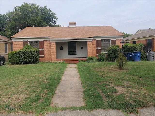 view of front of house with a porch and a front lawn