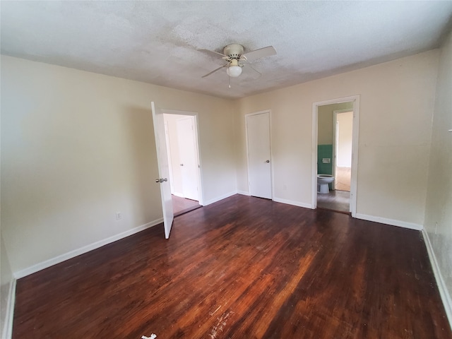 empty room featuring ceiling fan, dark hardwood / wood-style floors, and a textured ceiling