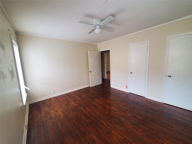 unfurnished bedroom with ornamental molding, dark wood-type flooring, and ceiling fan