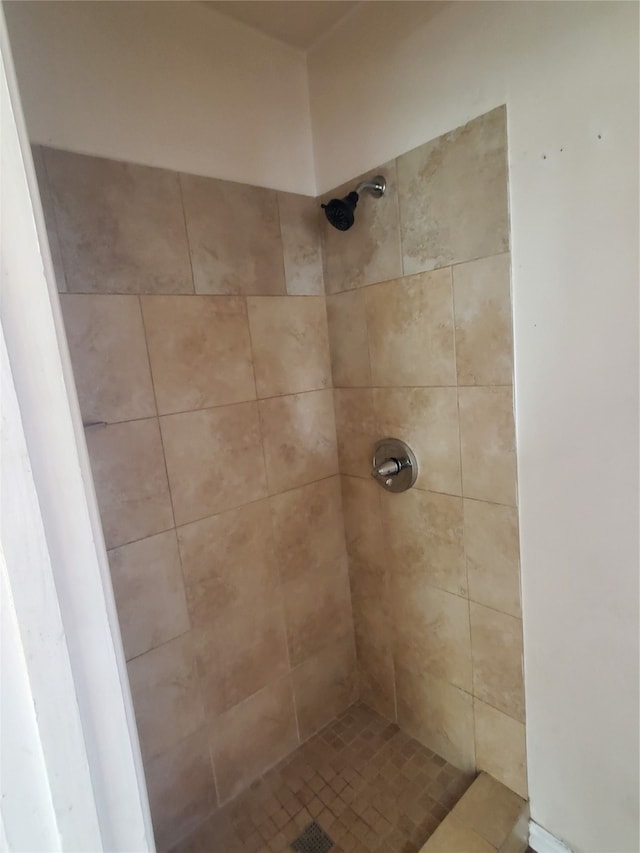 interior details with a tile shower