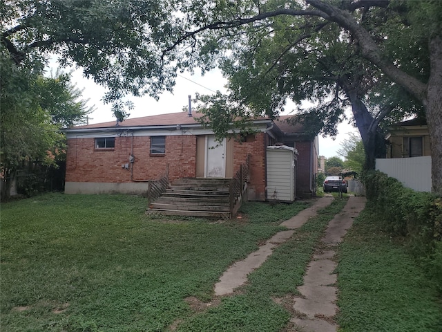 rear view of house featuring a lawn