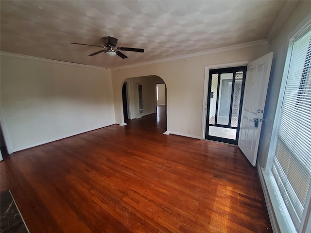 empty room with ceiling fan, crown molding, and dark hardwood / wood-style flooring